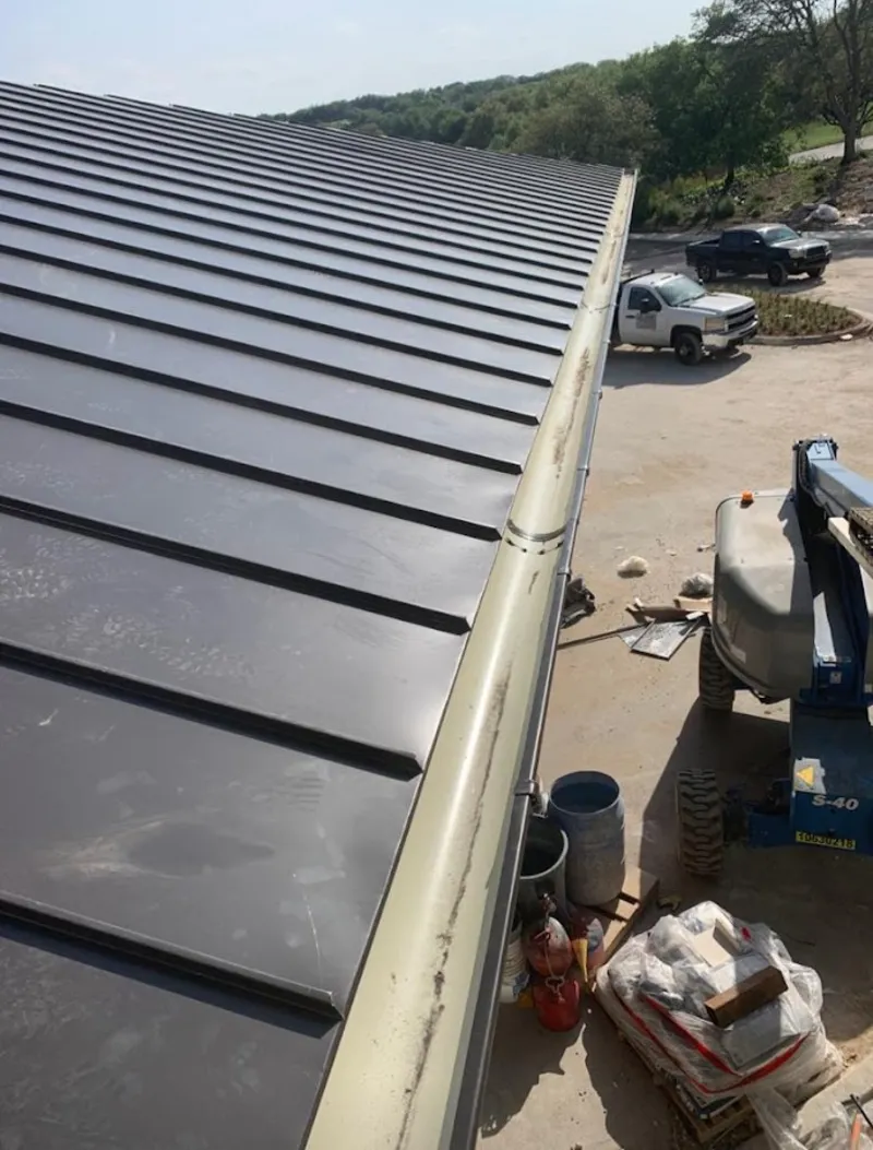 Standing seam panel and gutter detail on a metal roofing jobsite in Tabernacle